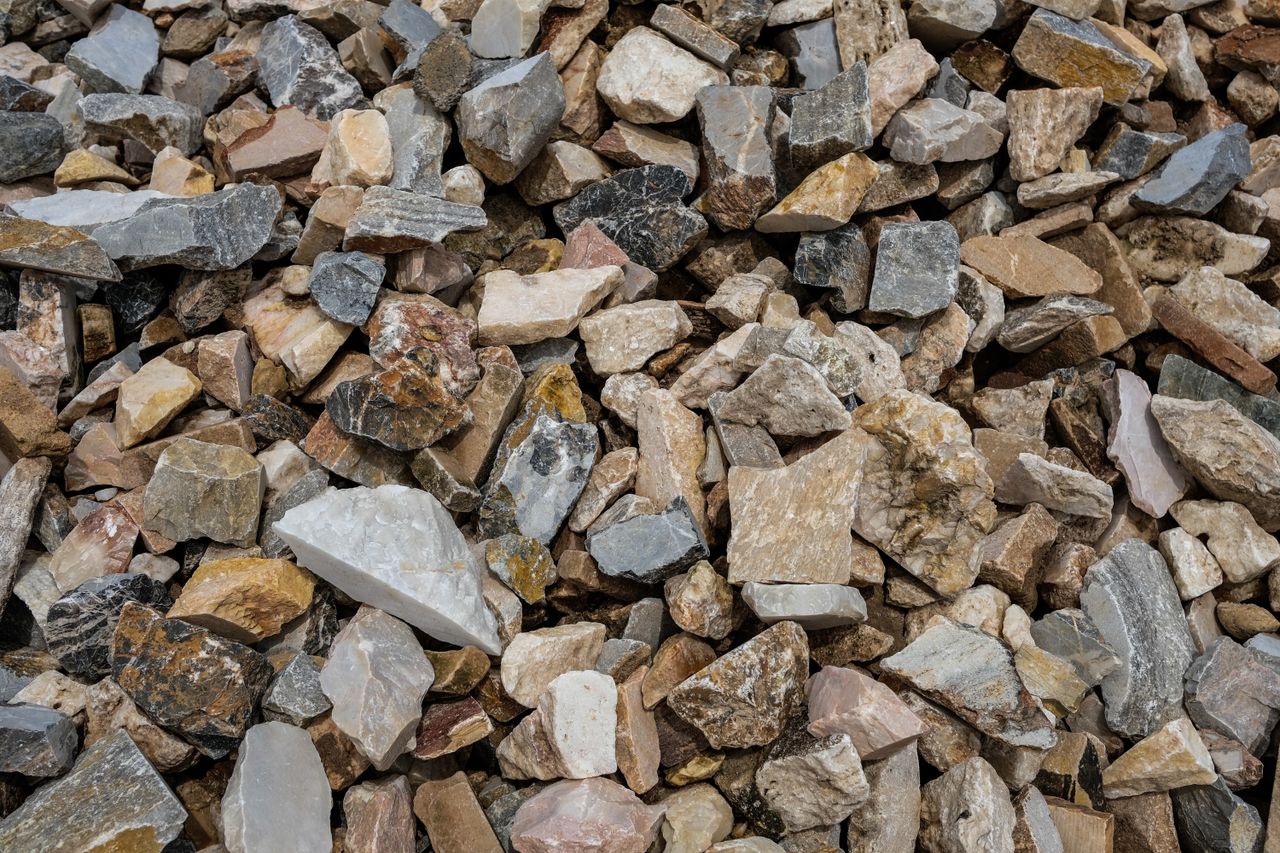 A diverse collection of natural stones with a rough and textured appearance.